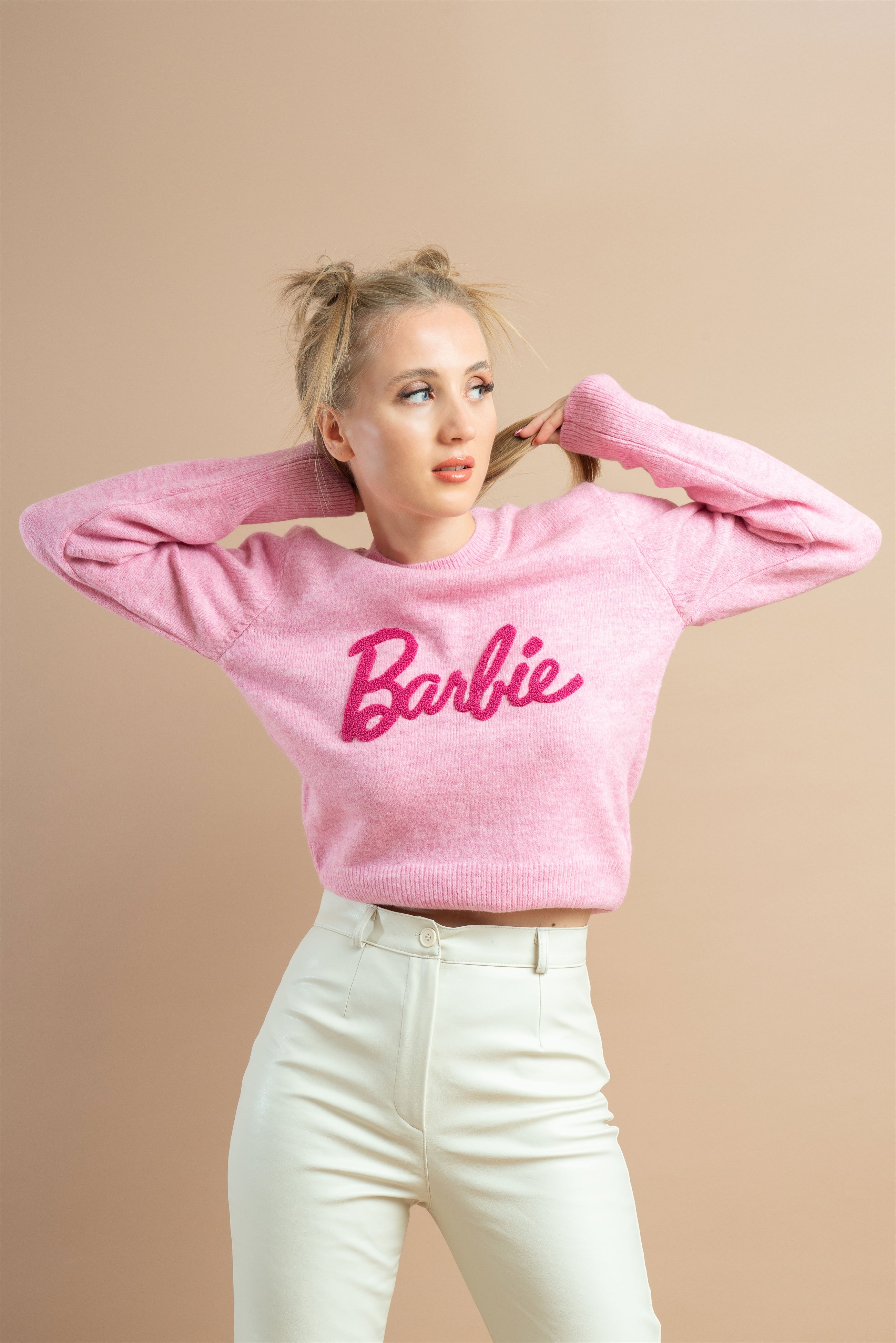 Baby Pink sweatshirt with a Barbie logo embroidery worn by a woman, for modern fashion look