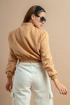 Stylish beige cropped winter jacket for women, offering warmth with long sleeves