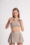 Sporty beige collared crop top and pleated skirt, a comfortable gym set for active women