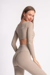 Beige full-sleeve crop top and matching high-waist yoga pants, perfect for workouts