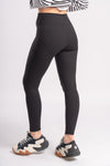 woman showcasing a black color yoga leggings for sporty look