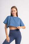 blue crop top styled with dark blue yoga pants