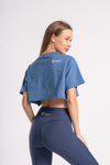 Blue crop top for women with short sleeves, suitable for layering in street style fashion.