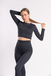 woman in a black color set of yoga leggings and crop top with breathable fabric