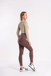 woman models in a brown yoga pants with sports shoes perfectly showing gym outfit