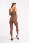 woman in back pose showing brown color full jumpsuit for workout sessions