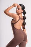 woman wearing a full length flared pants brown color jumpsuit suitable for gym 