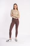 woman wearing a sports leggings paired with beige cropped top for chic look