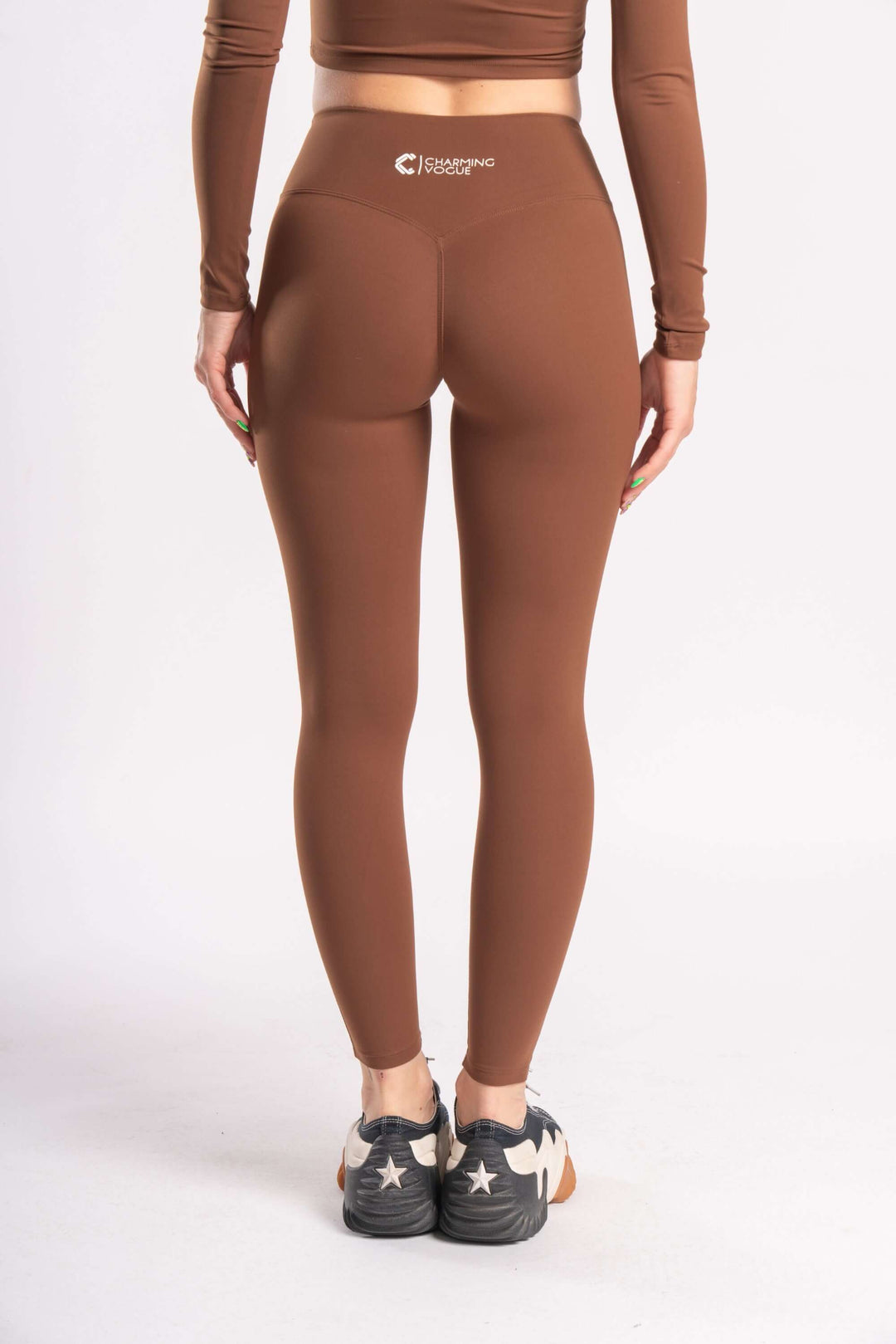 Stylist wearing brown color yoga pants of stretchable fabirc