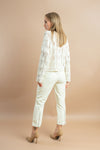 Chic white knitted cardigan with buttons and long sleeves for versatile outfits