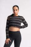 Stylish cropped knit top with a detailed pattern and long sleeves