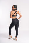 Woman in seamless black color yoga pants and sports bra set, perfect for high-intensity workouts