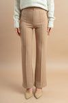 Cream-colored wide-leg trousers with a high waist and flowy, relaxed fit