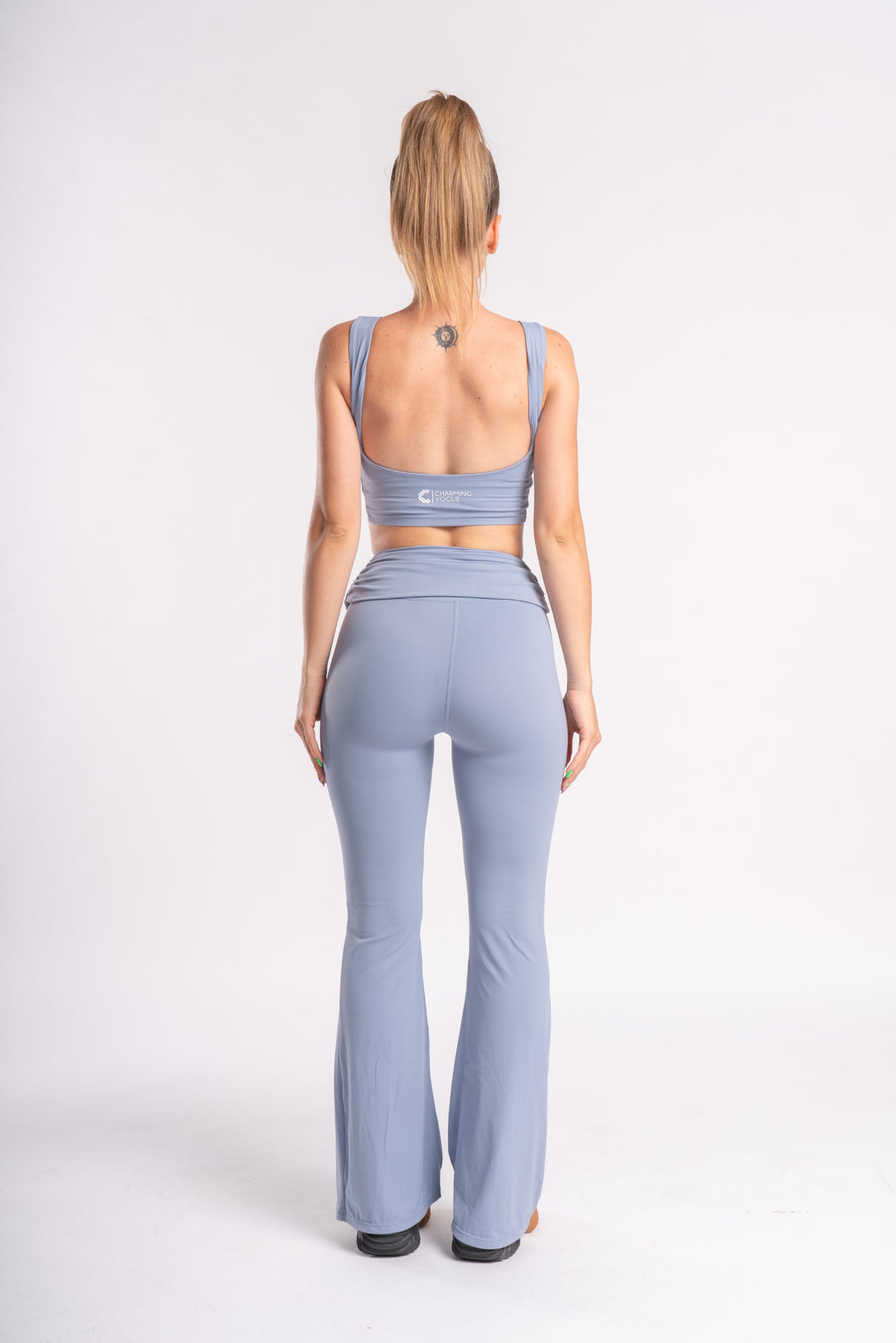 Sporty lavender crop top and high-waisted flare yoga pants, backless design