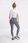 active wear worn by woman as crop top and yoga pants of off white color