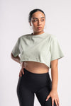 Oversized cropped top of olive green color featuring Charming Vogue