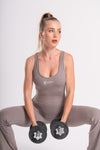 Stylish flared grey jumpsuit with backless design, perfect for yoga, CrossFit, and gym sessions