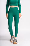 Flexible green leggings made from a stretchy material, offering comfort