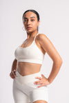 Women’s white activewear set with high-waist shorts and matching sports bra