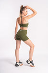 Women’s green halter neck workout set with ribbed bra and high-waist shorts