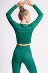 woman showcasing back look of the workout set of green color 