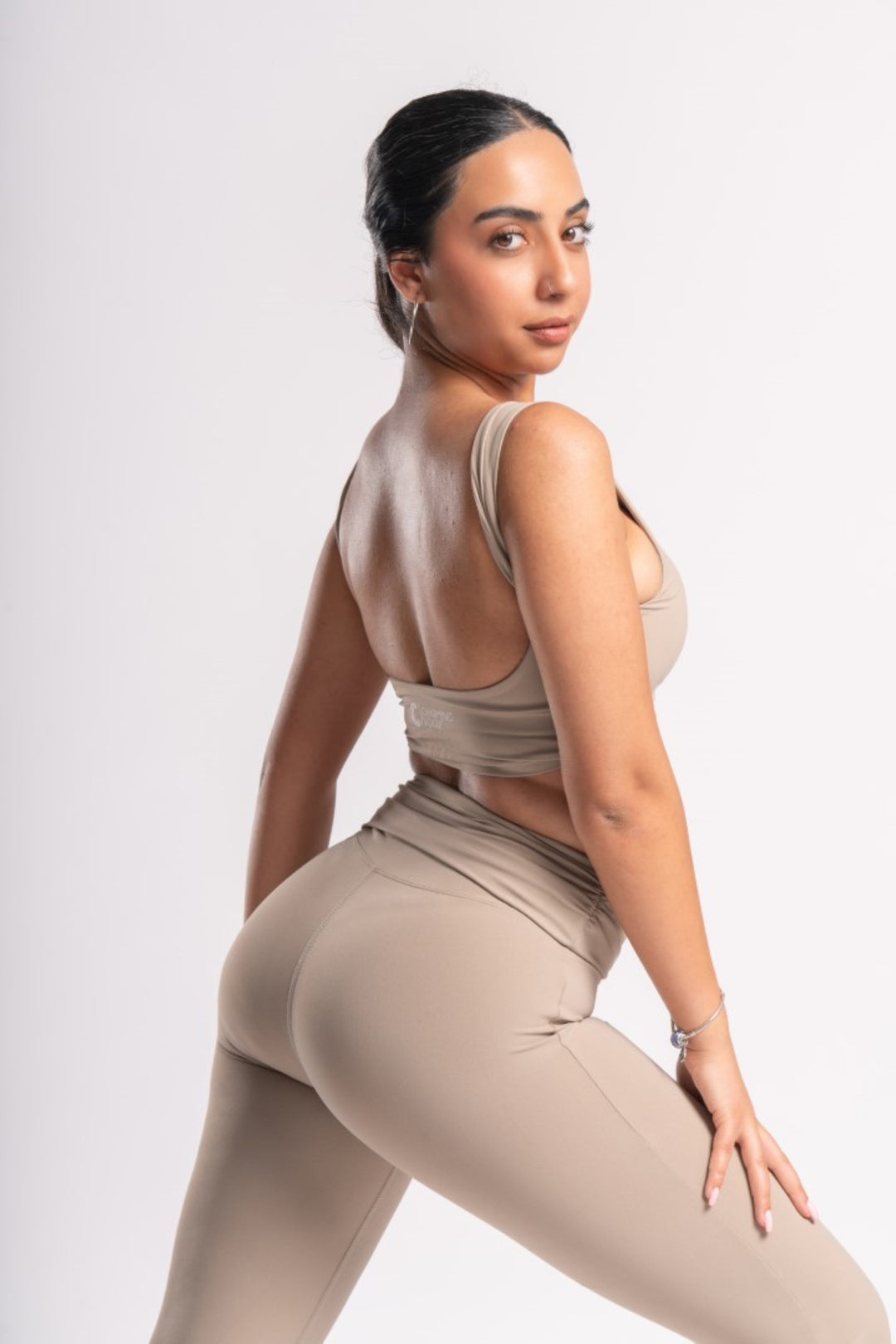 Back view of a backless crop top and high-waist flare yoga pants set.