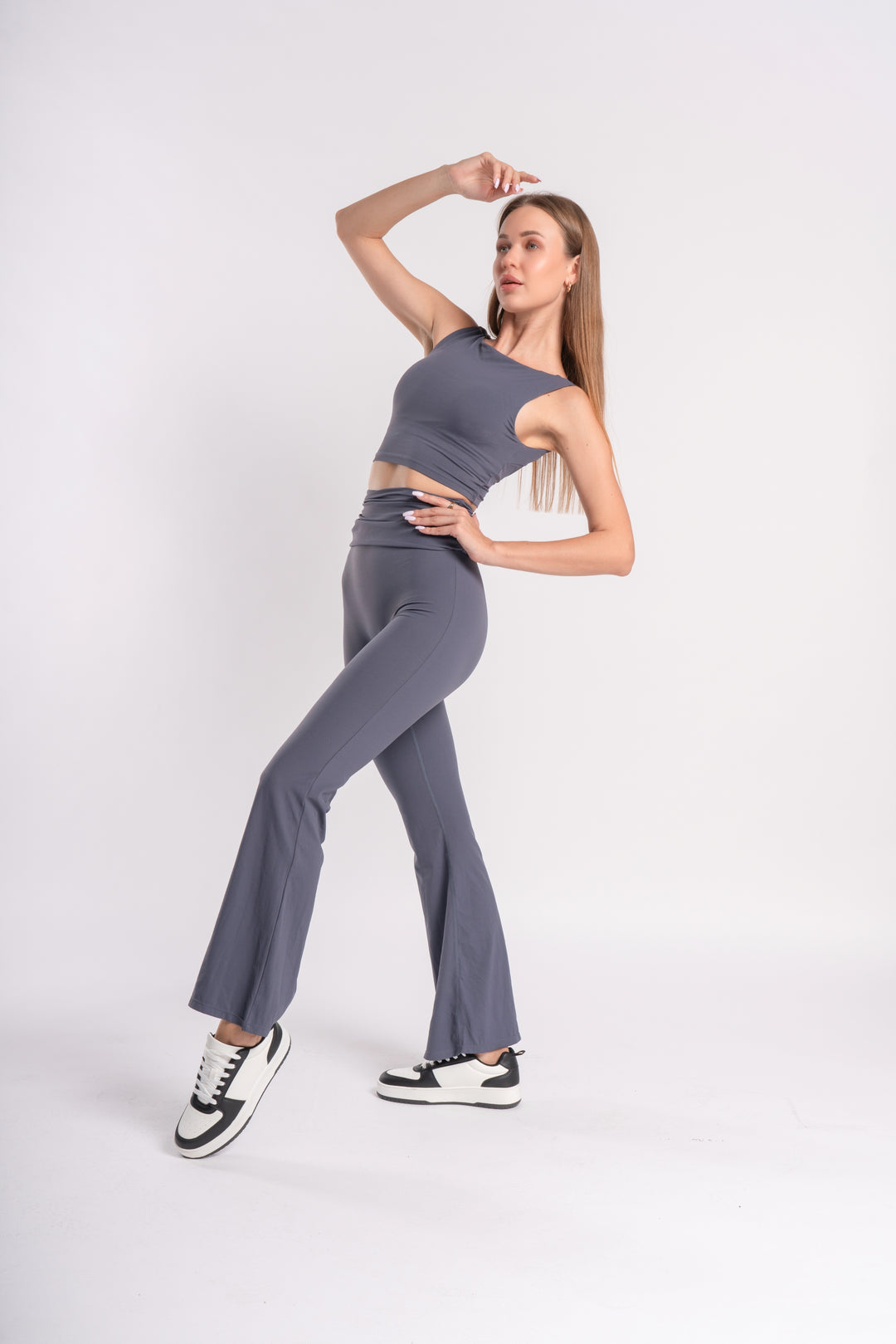 Sporty chic outfit featuring a backless crop top and flared yoga pants