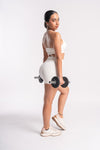 Women’s white gym outfit with sports bra and high-waisted shorts