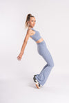 Lavender workout outfit featuring a sleeveless crop top and high-waist flared yoga pants