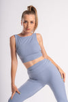 Back view of a lavender sleeveless crop top and flared yoga pants ensemble