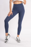 Women's compression blue sports leggings, providing support during intense yoga