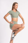 Olive green fitness set for women featuring crop top and shorts