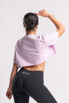 oversized cropped top pink color with black pants and white background perfect for gym wear