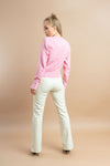 women wearing pink sweater with barbie logo in casual and trendy look