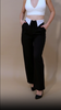 Women's black polyester trousers with a mid-rise waistband and a slim-leg silhouette