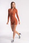 short unitard with a zipper front, offering a chic, form-fitting look