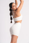 Breathable white sports bra and high-waist shorts set for women.