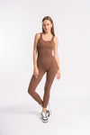 A model showcases a brown unitard highlighting a stylish athletic look