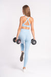 Matching blue color yoga leggings and cross-back sports bra - stylish gym wear set for women