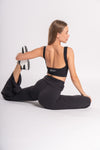 Sporty yet stylish backless crop top and flared yoga pants ensemble