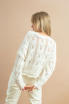 Elegant white cardigan sweater with full-length sleeves and button closure