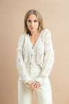 Knitted white cardigan with full sleeves and buttons for stylish winter layering