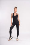 Backless black women's workout jumpsuit, designed for activewear and gym sessions