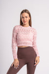 Detailed knit pattern on a cropped pink sweater top