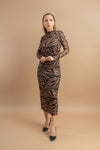 Model posing in a long-sleeved, tiger-patterned dress, showcasing a chic and bold fashion