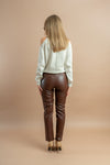 woman wearing a faux leather brown color trousers for office or everyday casual look