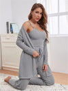 Woman posing in a chic grey ribbed lounge outfit, featuring a tank top