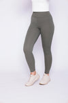 olive green leggings, presenting a chic and comfortable appearance