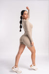 Women's zip-front long sleeve unitard in beige, ideal for yoga, fitness