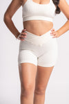 White women’s high-waisted shorts and padded sports bra set for workouts